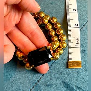KALAN by Suzanne Kalan gold beaded stretchy bracelet with black stone.